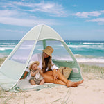 Mum and baby in pop-up beach tent, by Lozi & Gabe 
