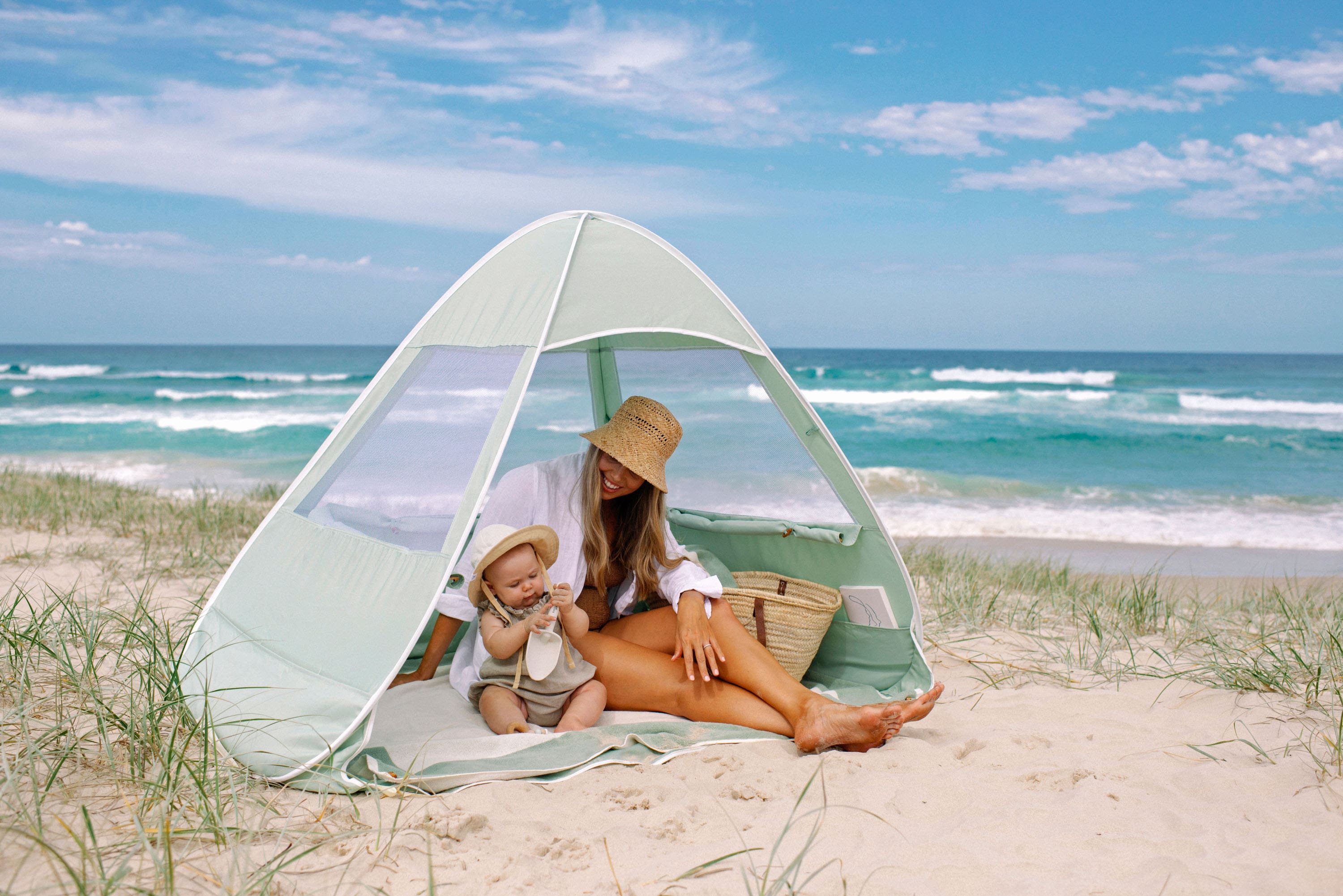 Mum and baby in pop-up beach tent, by Lozi & Gabe 